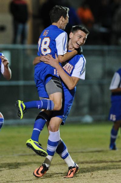 Bishop Gorman’s Jake Bickford (18) celebrates with Tristan Blackmon (11) after scoring ...