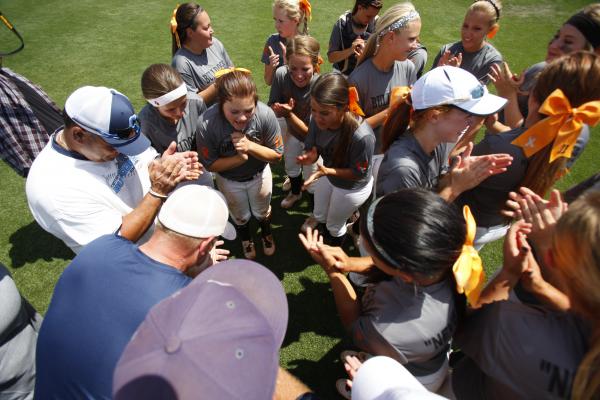 Centennial’s softball team and coaches huddle and begin to celebrate their state champ ...