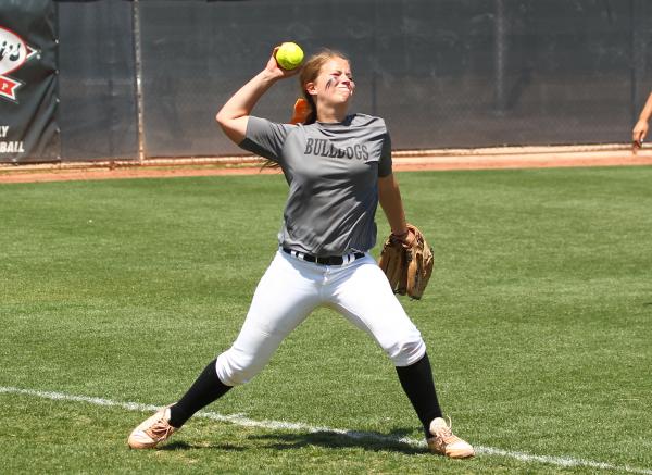 Centennial left fielder Lacie Chakos sets to throw after catching a fly ball.