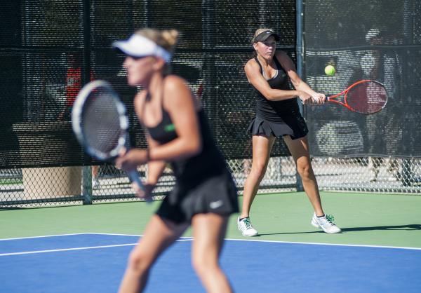 Palo Verde’s Chloe Henderson, right, hits a backhand as Sophie Henderson waits near th ...