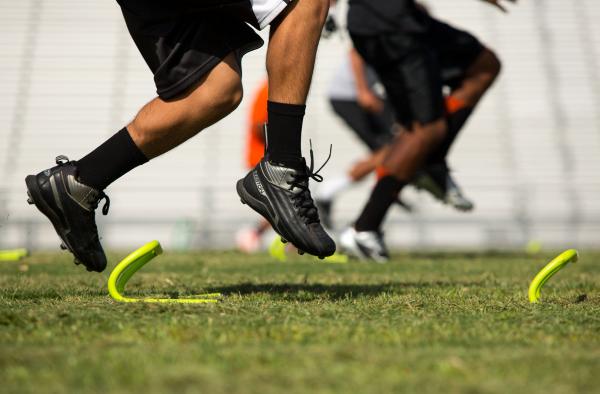 Chaparral football players run drills over ladders on Thursday. Before the school received a ...