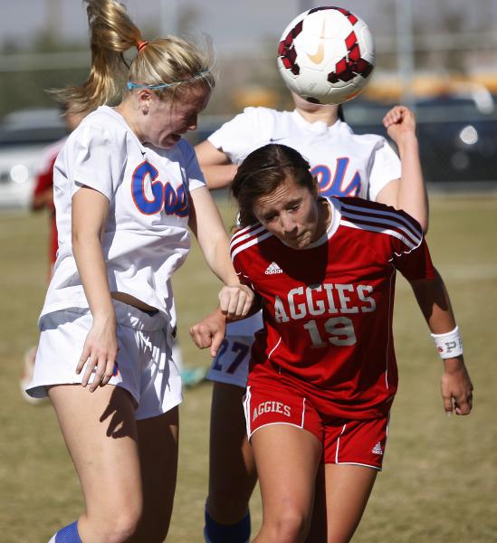 Tatum Buckley, left, of Bishop Gorman and Bailee Davis, right, of Arbor View go up for a hea ...