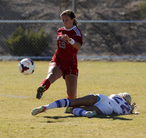 Arbor View’s Bailee Davis kicks the ball over Kaila Brinkman of Bishop Gorman during t ...