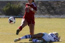 Arbor View’s Bailee Davis kicks the ball over Kaila Brinkman of Bishop Gorman during t ...