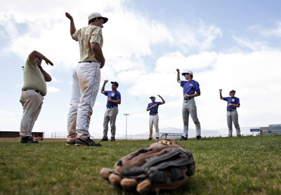 Members of the Sunrise Mountain High School varsity baseball team stretches before the start ...