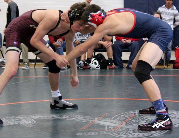 Faith Lutheran 145-pound freshman Tucker Prince ties up with Liberty junior Storm Roper, who ...