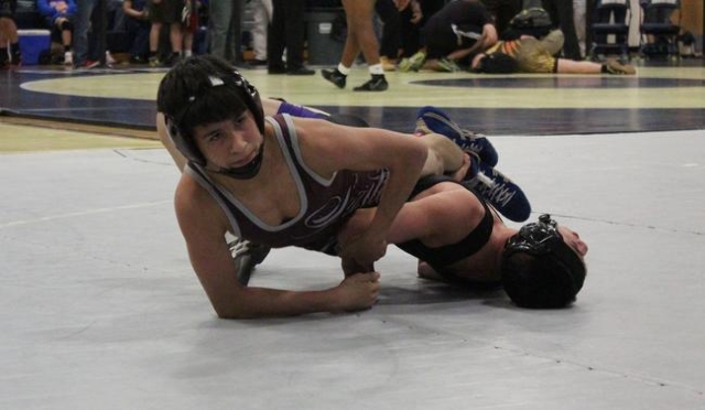 Cimarron-Memorial 113-pounder Nathaniel Rodriguez scissors his opponent, Durango‘s Bra ...