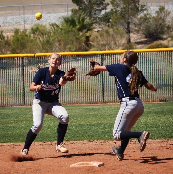 Centennial shortstop Heather Bowen, left, reaches out to make a catch while avoiding teammat ...