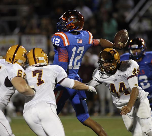 Bishop Gorman’s Randall Cunningham unloads a pass before getting hit by Mountain Point ...