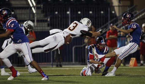 Salpointe Catholic’s Santiago Nieto (13) blocks a field goal attempt by Liberty’ ...