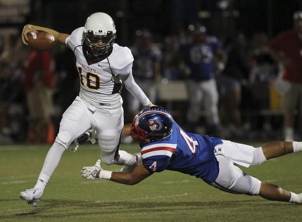 Salpointe Catholic’s Andrew Cota (10) escapes the grasp of Liberty’s Ethan Tuila ...