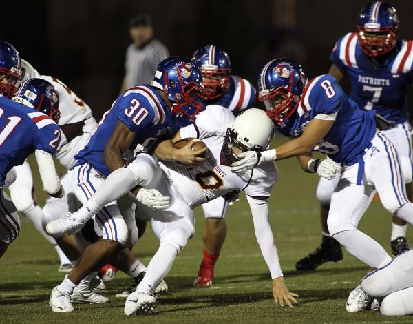 Liberty’s Curtis Washington (30) and Spencer Wilson (8) bottle up Salpointe Catholic&# ...