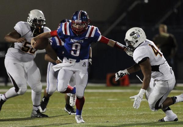 Liberty’s Tyler Newman (9) attempts to run past Salpointe Catholic’s Jason Parri ...