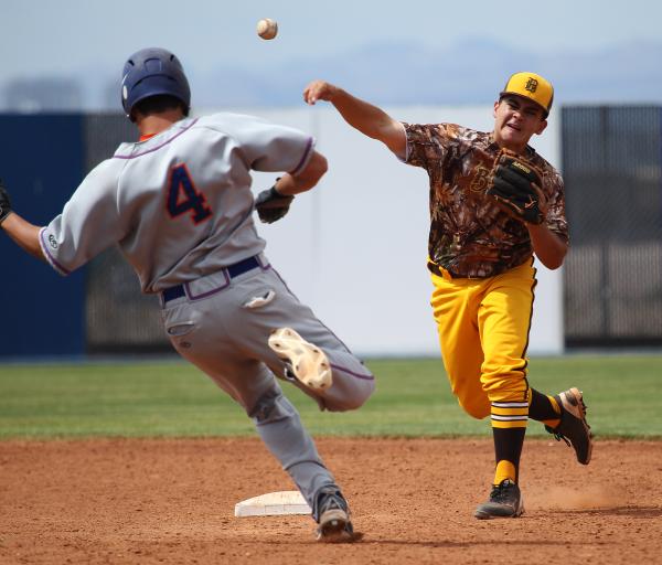 Bonanza second baseman Sean DeSoto tries to complete a double play as Bishop Gorman pinch-ru ...