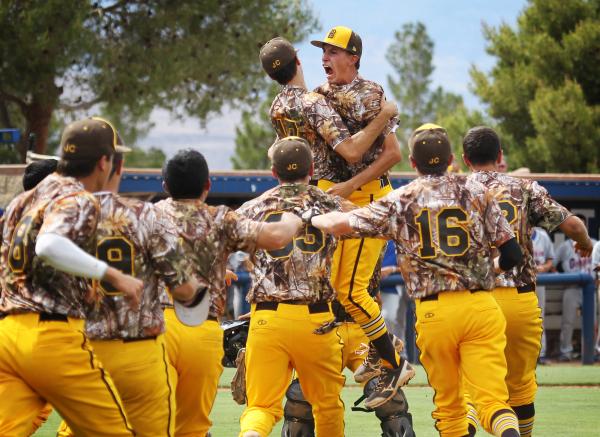 Bonanza reliever Dave Estrada gets mobbed by his teammates after recording the final out in ...