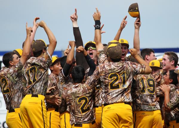 Bonanza head coach Derek Stafford, middle, celebrates with his team after defeating Bishop G ...