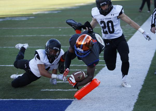 Daniel Stewart of Bishop Gorman dives into the end zone between Palo Verde’s Darrion F ...