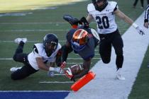 Daniel Stewart of Bishop Gorman dives into the end zone between Palo Verde’s Darrion F ...