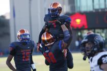 Nick Gates of Bishop Gorman holds up Daniel Stewart after Stewart scored a touchdown on Satu ...