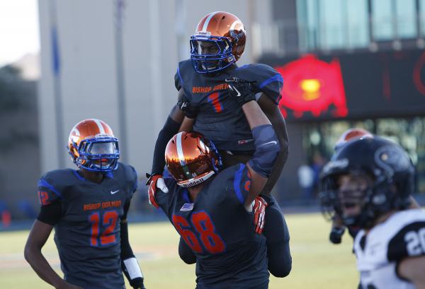 Nick Gates of Bishop Gorman holds up Daniel Stewart after Stewart scored a touchdown on Satu ...