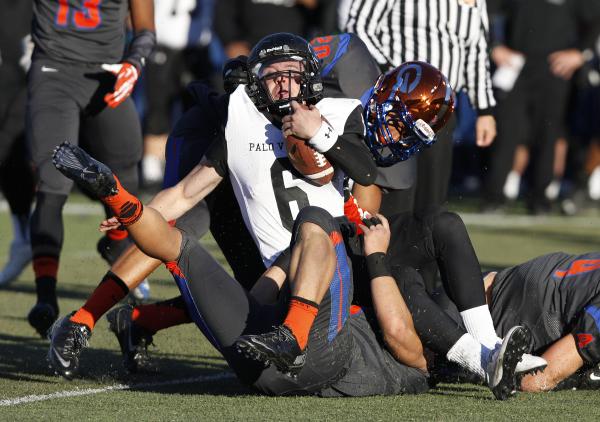 Bishop Gorman players bring down Palo Verde quarterback Parker Rost (6) on Saturday.