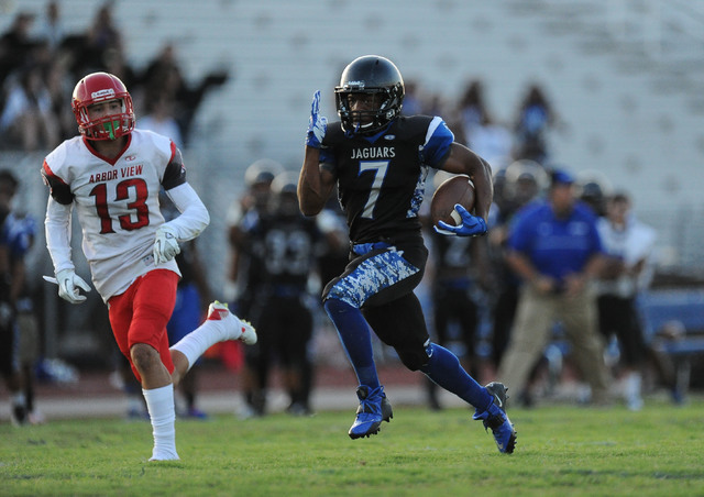 Desert Pines running back Isaiah Morris scores a touchdown on the opening drive of the game ...