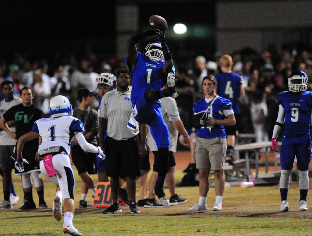 Green Valley Gators wide receiver Marquez Powell catches a pass for a first down against Bas ...