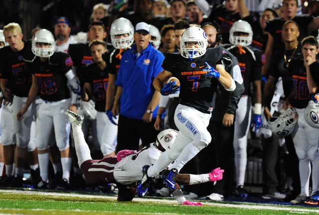 Bishop Gorman running back Biaggio Ali Walsh (7) runs past Don Bosco Prep Ironmen safety wid ...