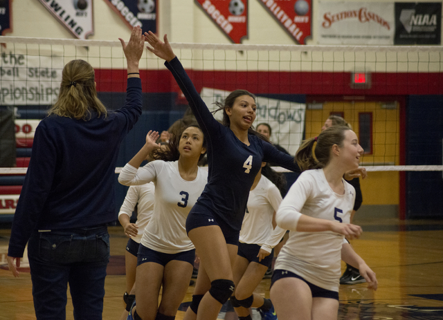 The Shadow Ridge High School girls volleyball team gives their coach, Karissa Guthrie, a hig ...