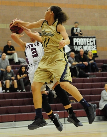 Spring Valley guard Kayla Harris (11) blocks the shot of Faith Lutheran guard Maddie Bocobo ...