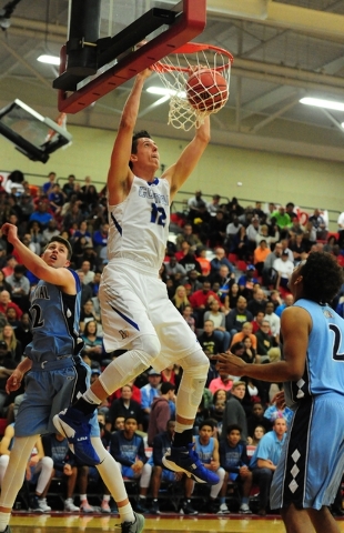 Bishop Gorman forward Zach Collins (12) dunks in front of Centennial guard Warren Price (12) ...