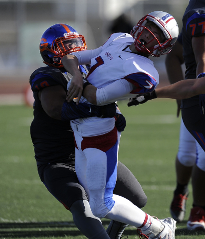 Bishop Gorman middle linebacker Nela Otukolo (10) tackles Liberty quarterback Kenyon Oblad ( ...