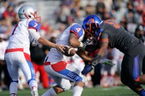 Bishop Gorman linebacker Ferrall Hester (53) forces a fumble as Liberty quarterback Kenyon ...