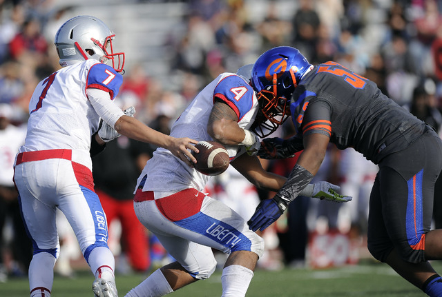 Bishop Gorman linebacker Ferrall Hester (53) forces a fumble as Liberty quarterback Kenyon ...