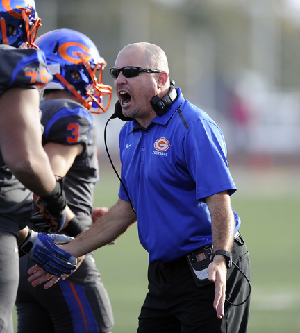 Bishop Gorman head coach Tony Sanchez celebrates with his players after Gorman scored a touc ...