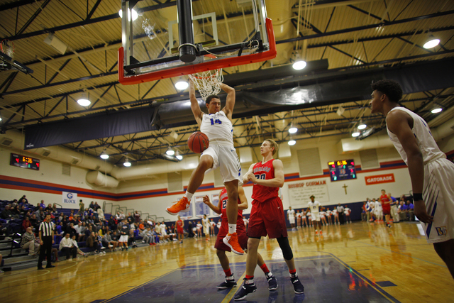 Bishop Gorman’s forward Saxton Howard (14) dunks against Coronado during a basketball ...