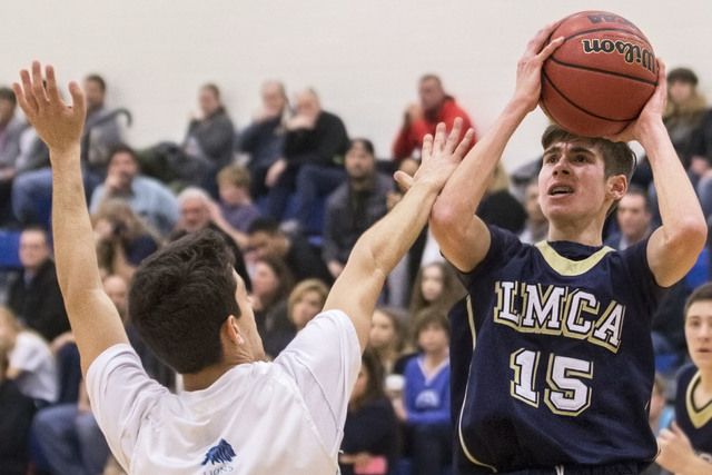 Lake Mead’s Shay Rutledge (15) shoots over Adelson School’s Liddor Bega (23) dur ...