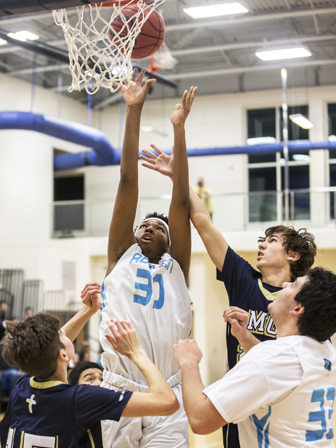 Adelson School’s Miles Hagan (30) fights for a rebound with Lake Mead’s Shay Ru ...