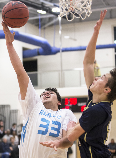 Adelson School’s Brandon Pappas (33) slashes to the rim past Lake Mead’s Joshua ...