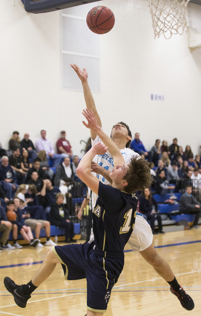 Adelson School’s Niv Shahmoon (11) shoots over Lake Mead’s Joshua Thorell (13) d ...