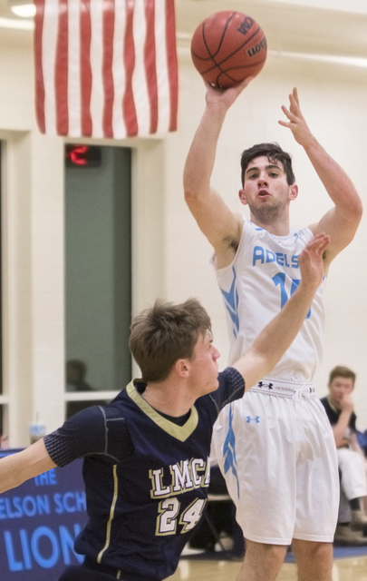 Adelson School’s Jake Buchman (15) shoots a three point shot over Lake Mead’s Ja ...