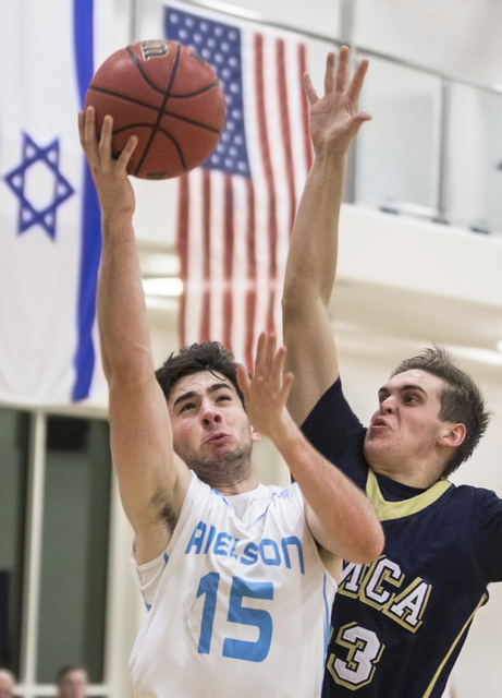 Adelson School’s Jake Buchman (15) slashes to the rim past Lake Mead’s Daniel P ...