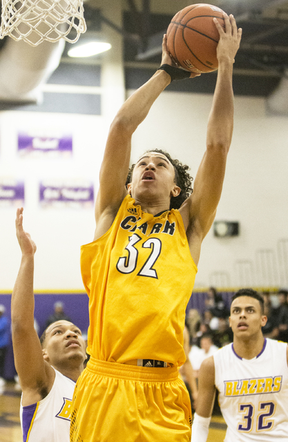 Clark’s Ian Alexander (32) shoots over Durango’s Demetrius Valdez (13) and Jerem ...