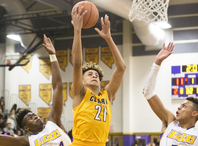 Clark’s Jalen Hill (21) drives past Durango’s Jeremie Portuondo (32) and Zyare R ...