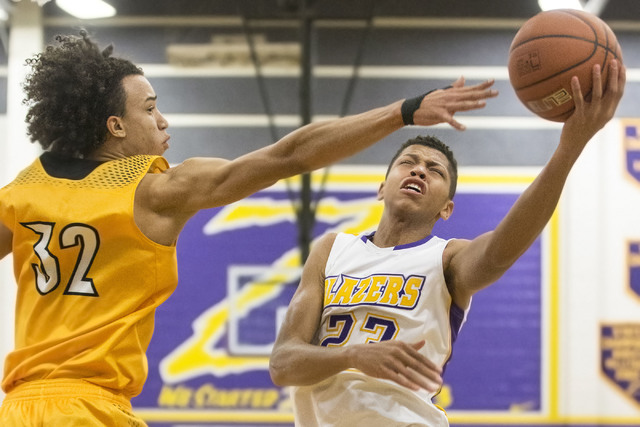 Durango’s Nicquel Blake (23) slices to the rim past Clark’s Ian Alexander (32) ...