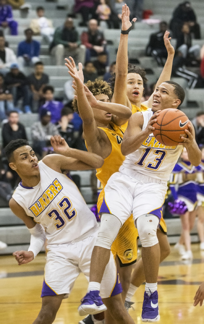 Durango’s Demetrius Valdez (13) drives to the basket past Clark’s Jalen Hill (23 ...