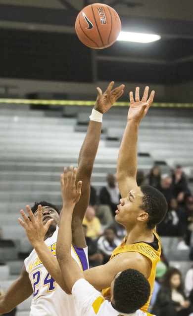 Clark’s Deshawn Wilson (5) shoots a jump hook over Durango’s Zyare Ruffin (24) d ...