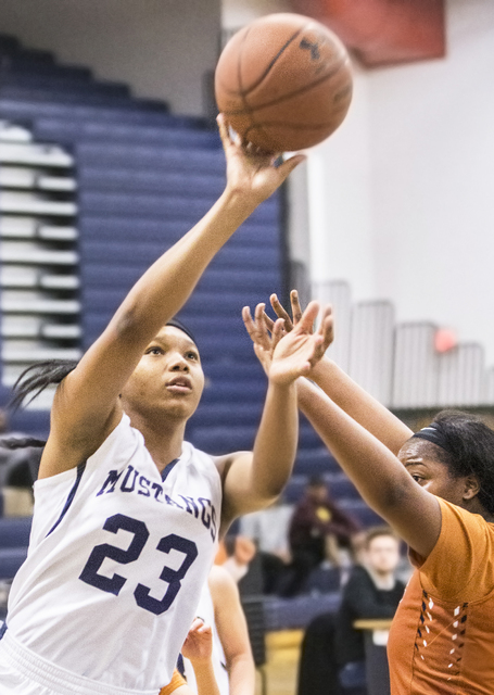 Shadow Ridge’s Isis Triplett (23) drives past Legacy’s Zania Watkins (42) during ...