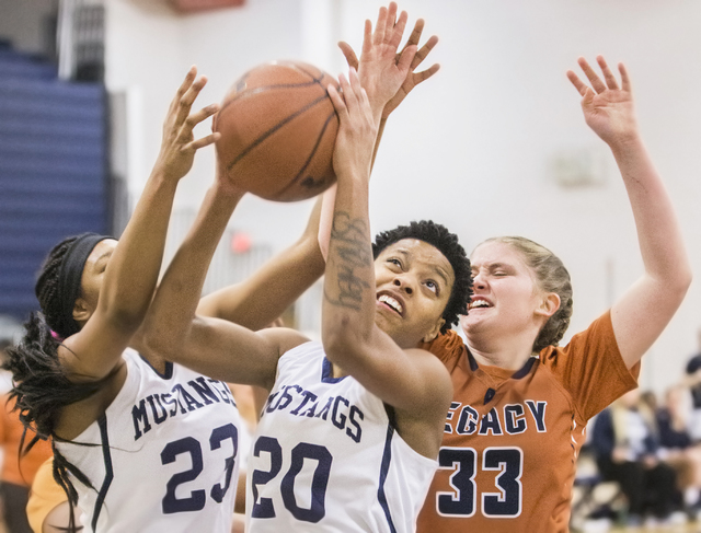 Shadow Ridge’s Summer Plunkett (20) grabs a loose ball over Legacy’s Samantha Gr ...