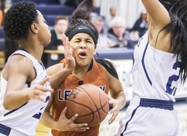 Legacy’s Taeha Pankey (3) is fouled by Shadow Ridge’s Summer Plunkett (20) while ...